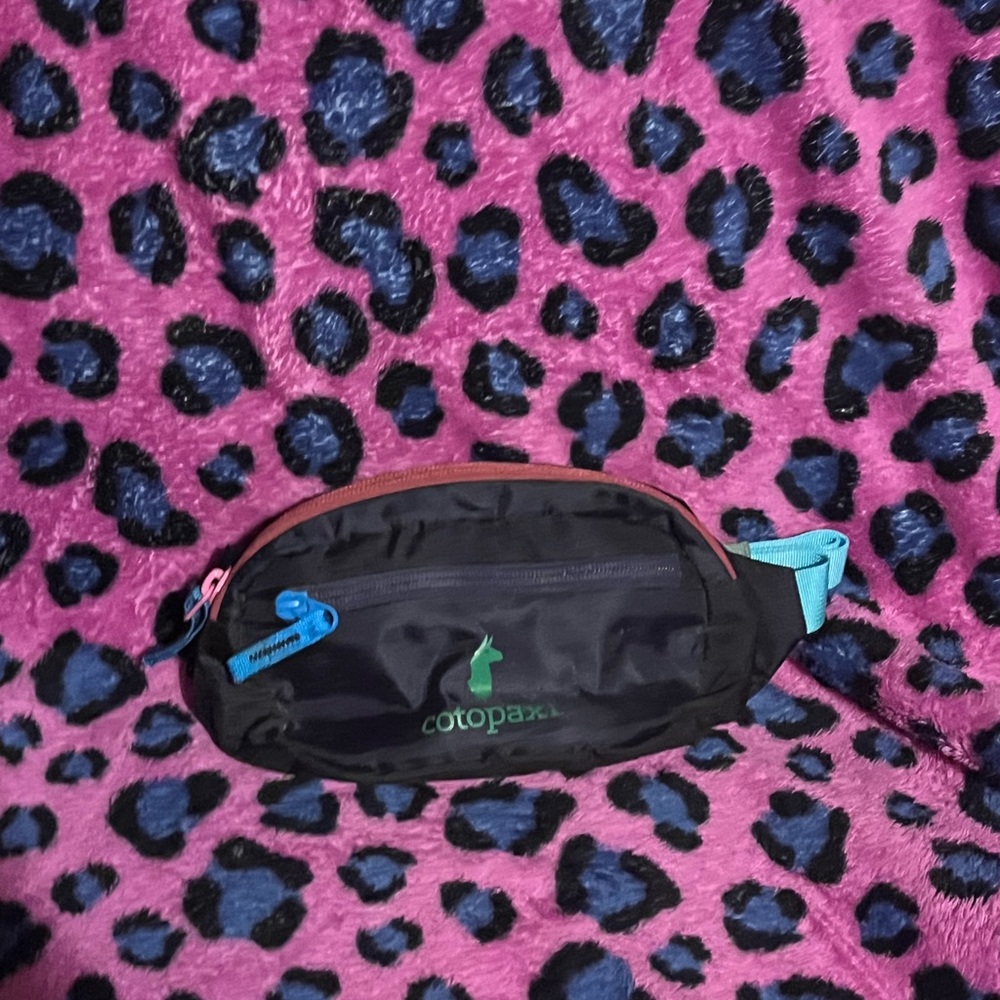 Cotopaxi Black Crossbody Bag with Blue and Pink Accents